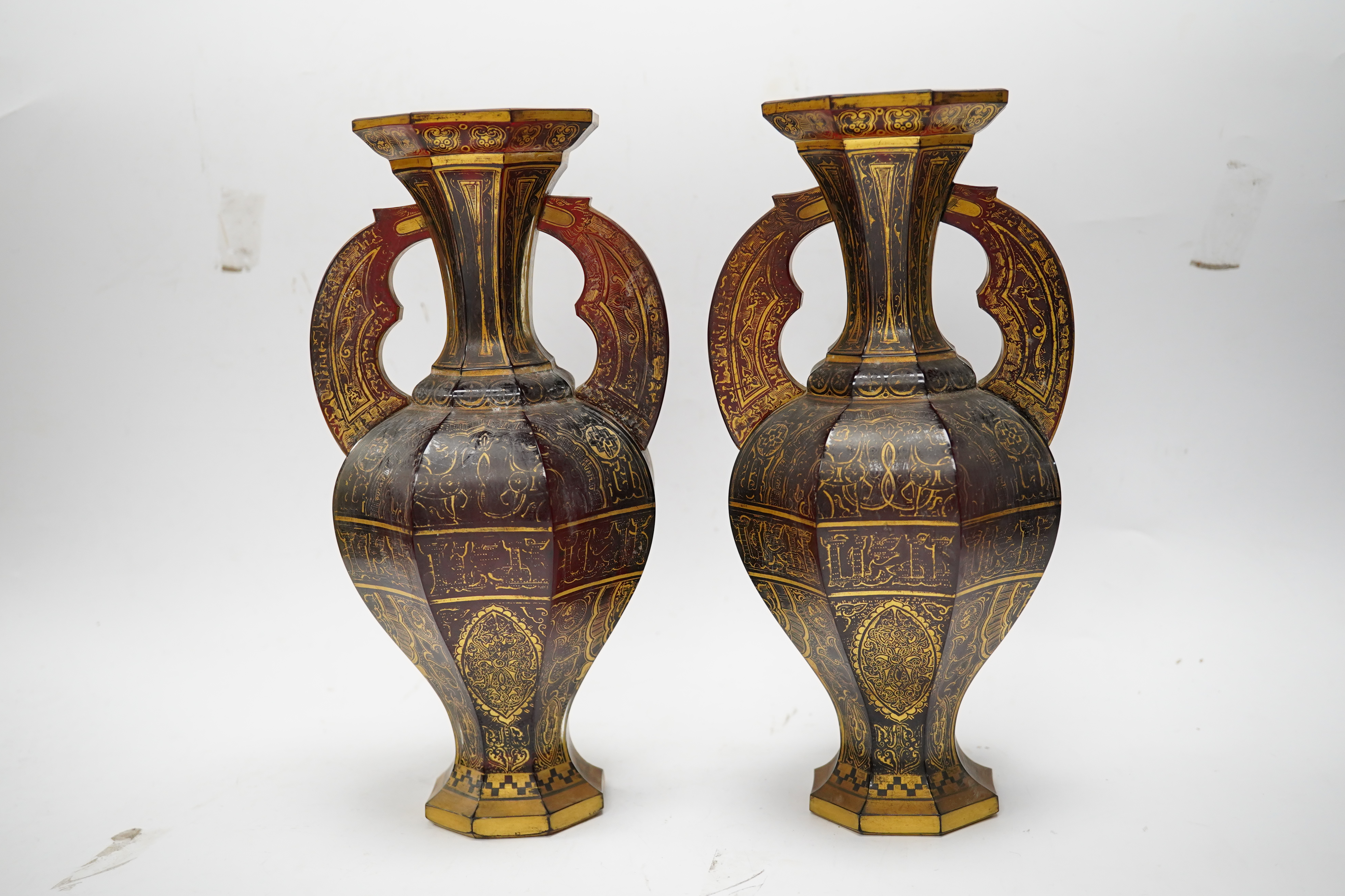 A pair of Venetian Islamic inspired gilt decorated ruby glass twin handled vases, 24cm high. Condition - wear to gilding on both vases